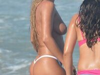 Busty blonde posing naked at beach