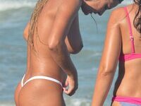 Busty blonde posing naked at beach