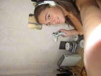 Cute brunette playing video games naked at home