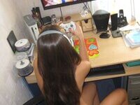 Cute brunette playing video games naked at home