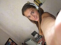 Cute brunette playing video games naked at home