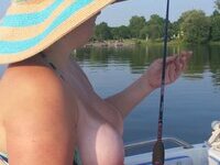 Young wife flashing on boat