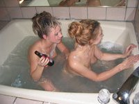 Two girls are taking bath and shave pussy