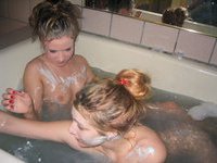 Two girls are taking bath and shave pussy