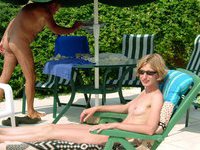 Sunbathing naked by the pool