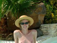 Sunbathing naked by the pool