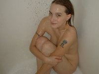 Tattooed babe taking a bath