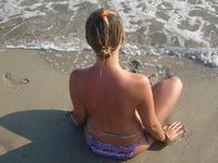 Cute naked babe on the beach