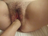 Fisting her hairy pussy deep