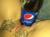 Girl with a bottle of pepsi in pussy